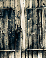A 1700s door with old rustic wood and hinges 
