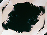 A top view looking down on the head and upper torso with arms wrapped around the shoulders