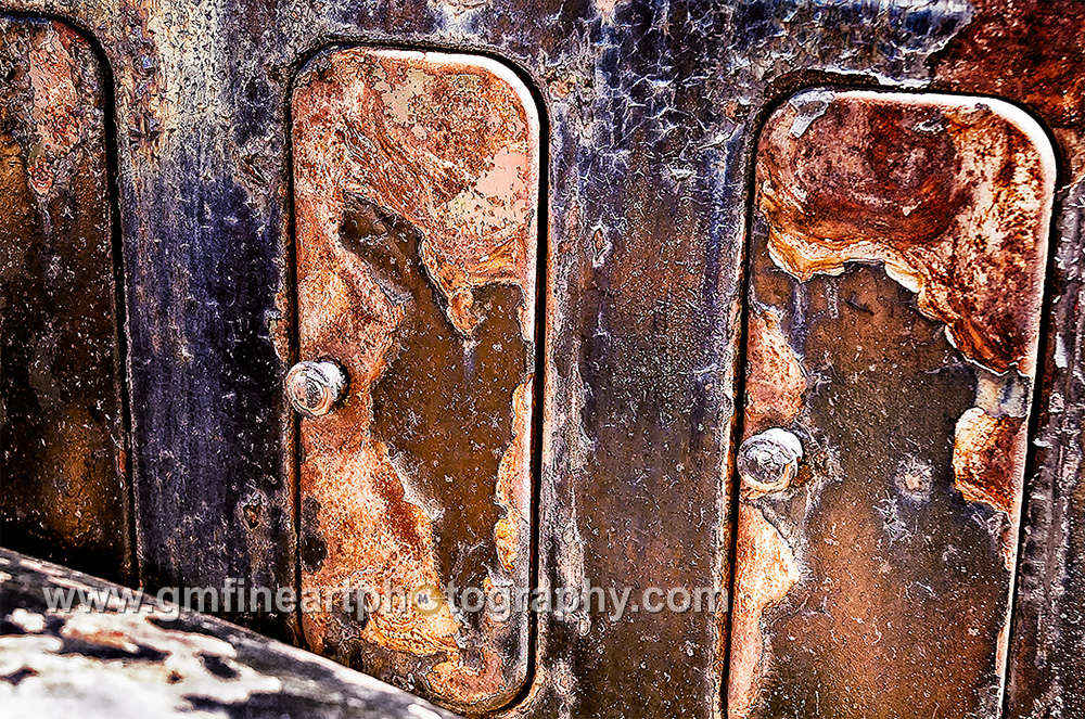 Three rusty hood vents in a row of an old 1930s car 